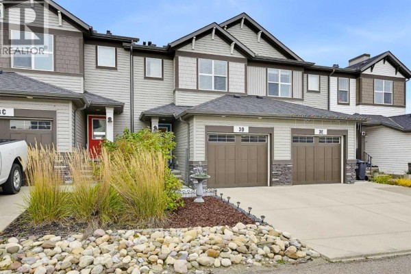 Front exterior of a townhouse complex showing units 3C, 3D, and 3E with landscaping. - 3d Heritage Drive, Cochrane