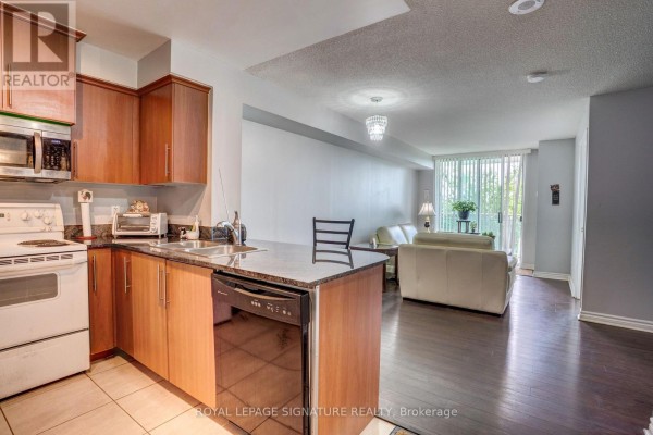 Fitness room with treadmills, elliptical machines, and a television. - 3m - 8 Rosebank Drive, Toronto