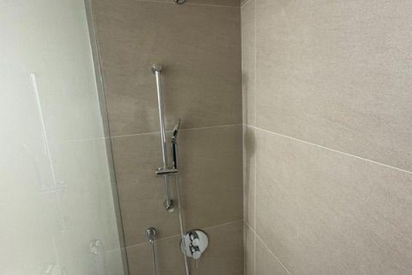 Close-up of a modern shower stall with tiled walls and chrome fixtures. - 4 - 152 Brunswick Avenue, Toronto