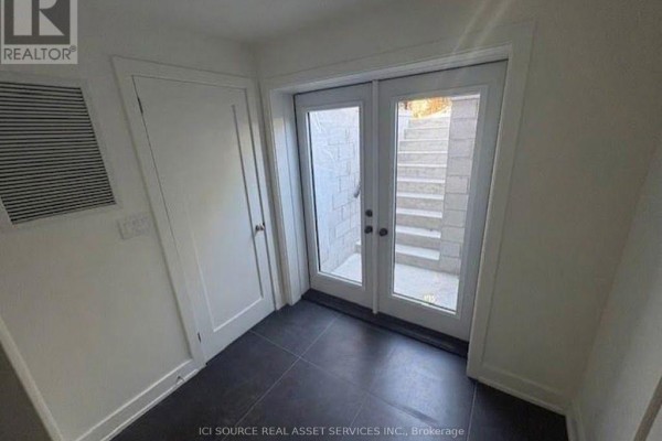 Interior hallway with double glass doors leading to outdoor stairs. - 4 - 152 Brunswick Avenue, Toronto