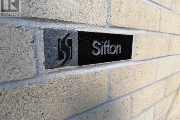 Close-up of the Sifton logo on a beige brick exterior wall. - 4 - 163 Pine Valley Drive, London South