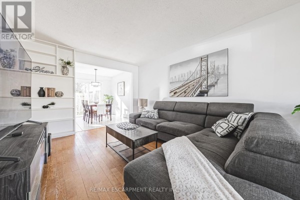 Cozy living area with large windows, sectional sofa, and coffee table - 4 - 2220 Upper Middle Road, Burlington