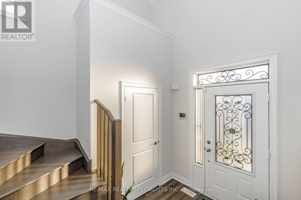Bathroom with a bathtub, tiled shower surround, vanity, and decorative mirror. - 4 - 230 Farley Road, Centre Wellington