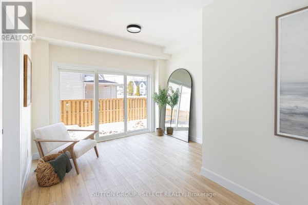 Interior hallway with white doors, light wood flooring, and a staircase leading upstairs. - 4 - 233 Upper Queen Street, Thames Centre