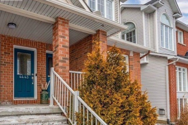 Close-up of the blue front door with house number 4443 and a covered porch. - 4 - 4443 Harper Avenue, Ottawa