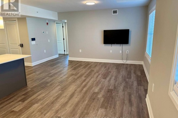 Laundry area with stacked washer and dryer, water heater, and furnace. - 4 - 6 Ann Street, Thorold