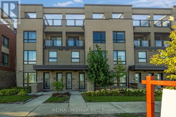 Exterior view of the townhouse with a sidewalk, green space, and street. - 4 - 624 Rexdale Boulevard, Toronto