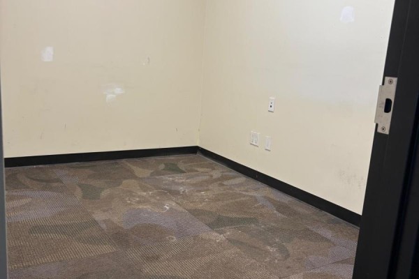 Hallway leading to glass doors and a yellow caution sign. - 4 - 669 10th Street W, Owen Sound