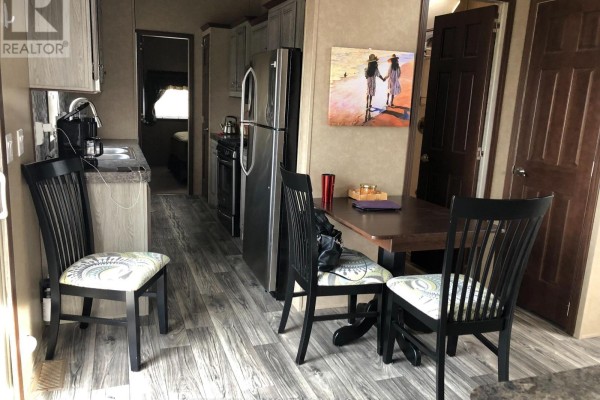 Kitchen and dining area with stainless steel appliances, table, and black chairs - 4 - 77719 Bluewater Highway, Central Huron