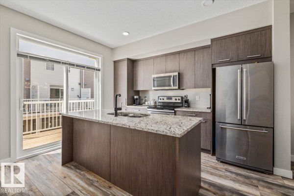 Entryway with a gaming chair in a small nook and a door to the outside. - #4 1636 Kerr Rd Nw, Edmonton