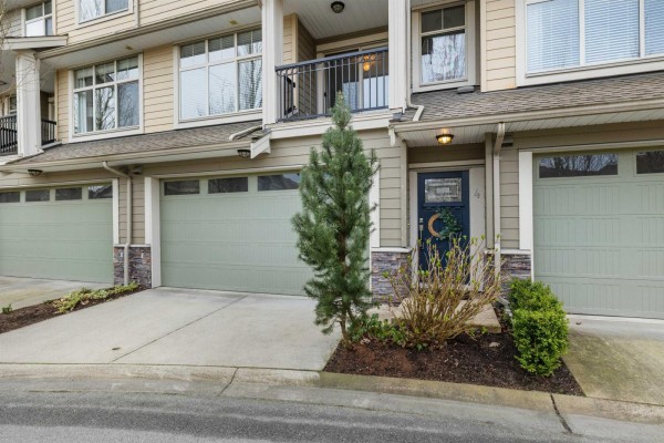 A bedroom with a queen-size bed, two nightstands, and a large window with blinds. - 4 22225 50 Avenue, Langley