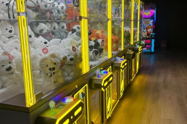 Long row of stuffed animal claw machines with bright yellow lighting - 4-5 - 2150 Dunwin Drive, Mississauga