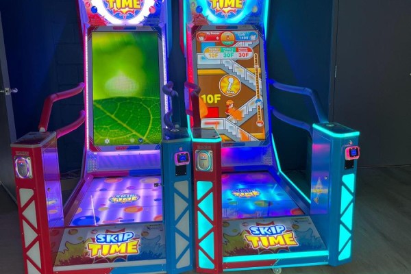 Two colorful 'Skip Time' arcade game machines with screens and controls - 4-5 - 2150 Dunwin Drive, Mississauga