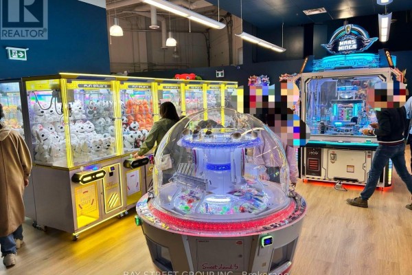 Interior view of a commercial arcade with multiple claw machines and game cabinets - 4-5 - 2150 Dunwin Drive, Mississauga