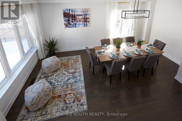 Dining table with 8 chairs, decorative rug, large windows, modern chandelier - 4 Boville Court Oro Medonte