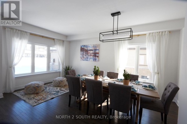 Dining room with table, chairs, chandelier, rug, and artwork - 4 Boville Court Oro Medonte