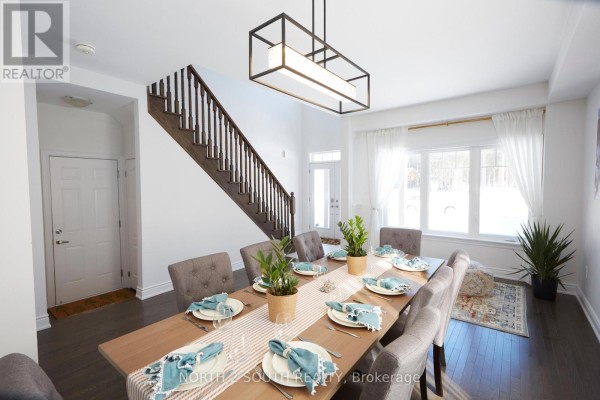 Dining room with table, chairs, chandelier, and staircase - 4 Boville Court Oro Medonte
