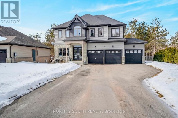 Driveway leading to a large grey house with a triple garage and snow banks. - 4 Boville Court, Oro Medonte