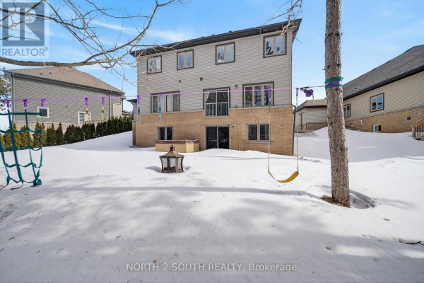 Backyard with hot tub, fire pit, swing, and climbing net - 4 Boville Court Oro Medonte