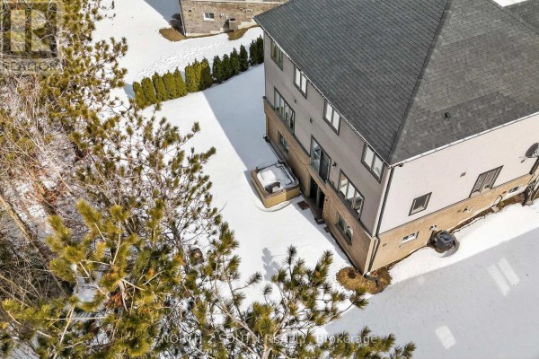 Backyard with hot tub, trees, and snow - 4 Boville Court Oro Medonte