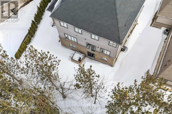 Backyard with hot tub and snow - 4 Boville Court Oro Medonte