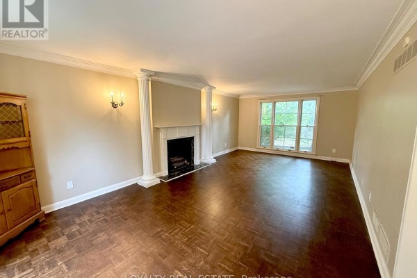Living room with a white fireplace, dark hardwood floors, large window, and built-in cabinetry. - 4 Canadiana Drive, Markham