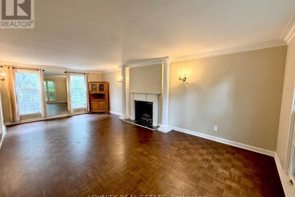 Spacious living room with fireplace, parquet flooring, large windows, and glass doors leading outside. - 4 Canadiana Drive, Markham