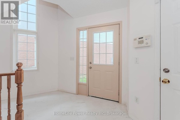 Interior entryway with natural light, front door, and tiled floor. - 4 Darling Crescent, Guelph