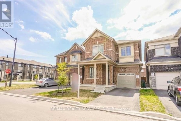 Exterior view of a brick house with a driveway and garage. - 4 Divers Road, Brampton