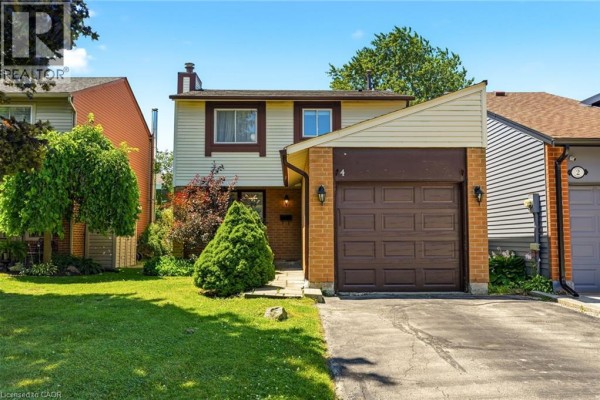 View of the house entrance with a garage door and walkway. - 4 Eileen Street, Waterdown