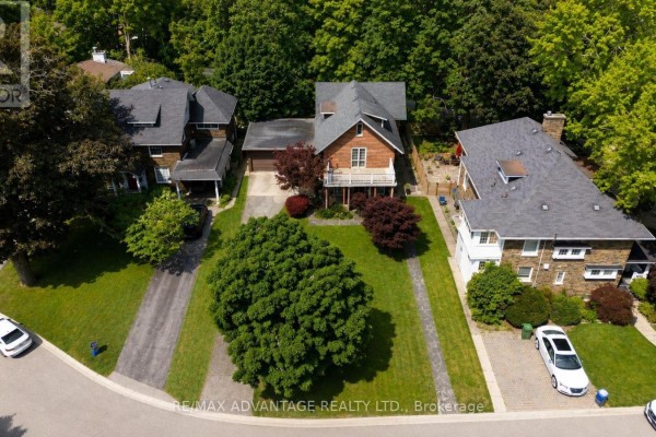 Front exterior of a brick house with a balcony on the second story, surrounded by trees. - 4 Farley Place, St  Thomas