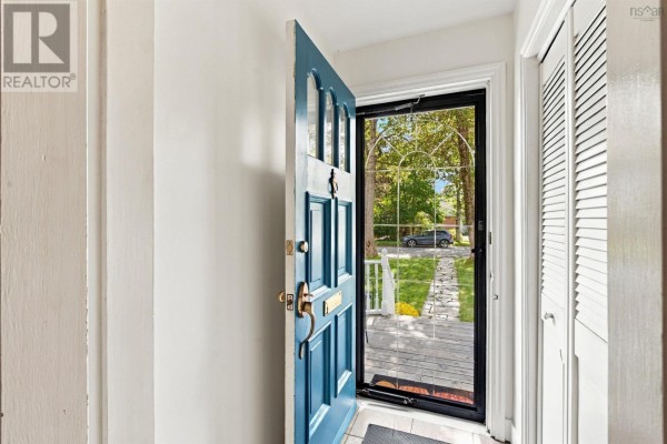 View from inside the entryway looking out the open blue front door to the stone walkway and front yard. - 4 Fleming Drive, Halifax