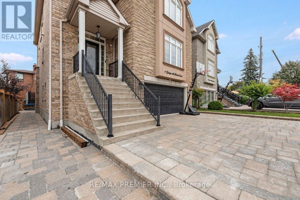 Close-up of the stone exterior and stairs leading to the front door of a house. - 4 George Mckenzie Court, Toronto