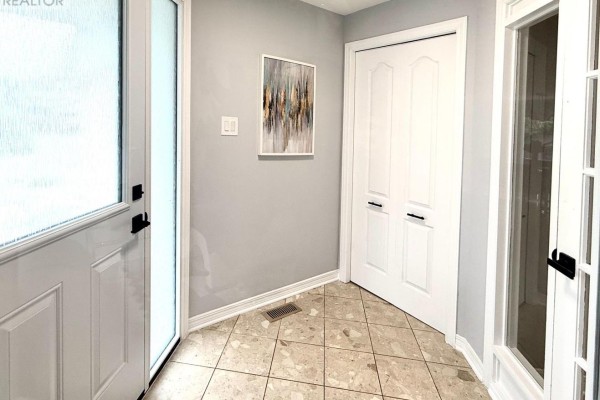 Interior entryway with a glass door, light grey walls, and a tiled floor. - 4 Glenarden Court, Ottawa