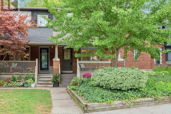 Two attached brick houses with separate front porches and mature trees. - 4 Kenrae Road, Toronto