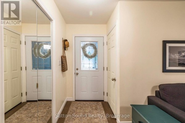 Open concept living, dining, and kitchen area with patio doors and large windows. - 4 Maplewood Drive, South Bruce Peninsula