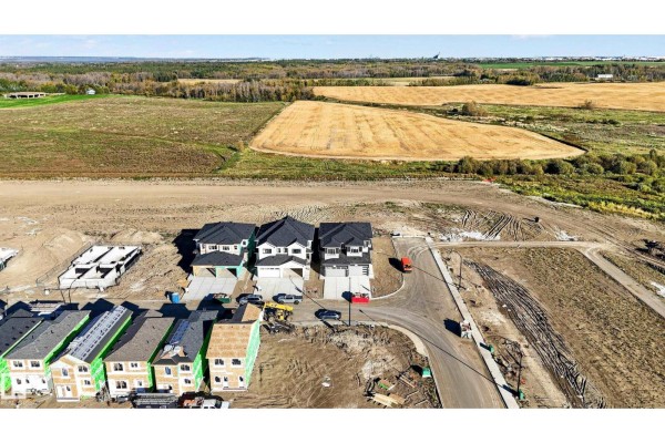 Aerial view of a new housing development with duplexes and construction sites. - 4 Parker Ln, Spruce Grove