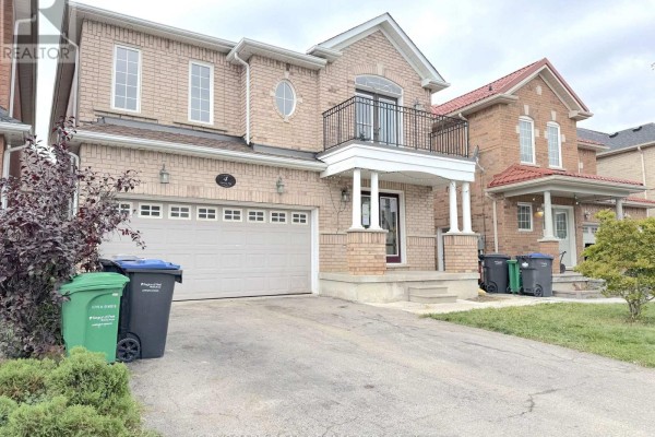 Side view of the house, showcasing the brick exterior and garage. - 4 Savita Road, Brampton
