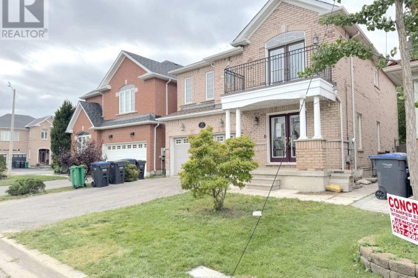 Partial side view of the house with a small tree and green lawn. - 4 Savita Road, Brampton
