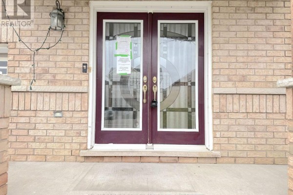 Close-up of the double front doors with decorative glass panels. - 4 Savita Road, Brampton