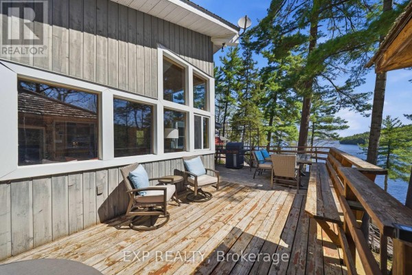 Waterfront deck with seating, grill, and lake view - 4 Stackwall Lane Greater Madawaska