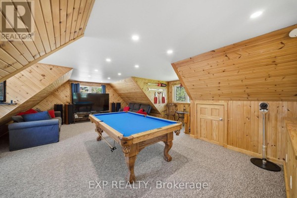 Pool table and sofa in finished basement with wood paneling - 4 Stackwall Lane Greater Madawaska