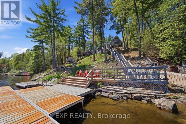 Wooden dock and stairs leading to a lakefront home - 4 Stackwall Lane Greater Madawaska