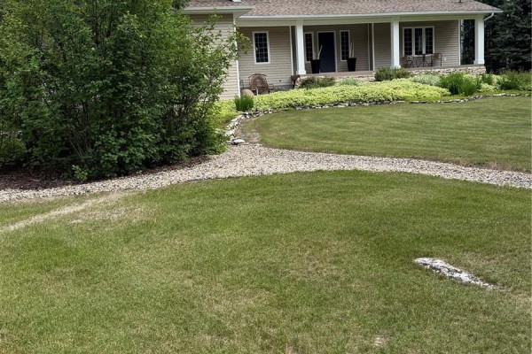 Two deer grazing on a green lawn with a wooded forest in the background. - 4.96 Acres Move In Ready Property, Hudson Bay Rm No  394
