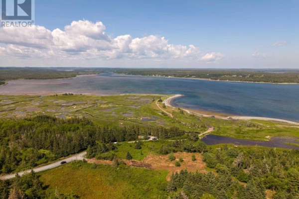 Aerial view of a bay and surrounding green landscape with a road and trees. - 40  Acre Lot Conrod Beach Road, Lower East Chezzetcook