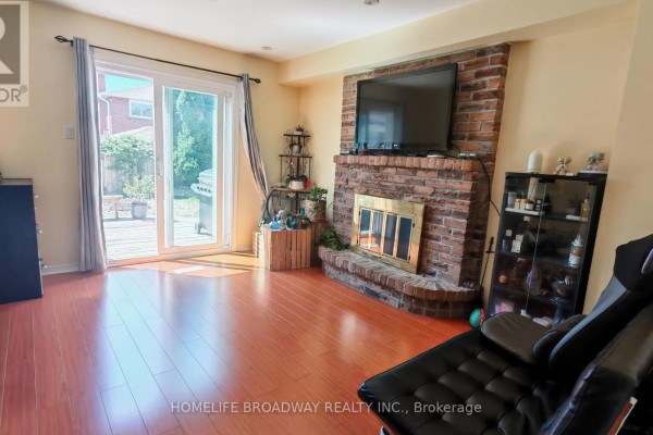 Outdoor deck with a sectional sofa, glass coffee table, and barbecue grill. - 40 Bendamere Crescent, Markham