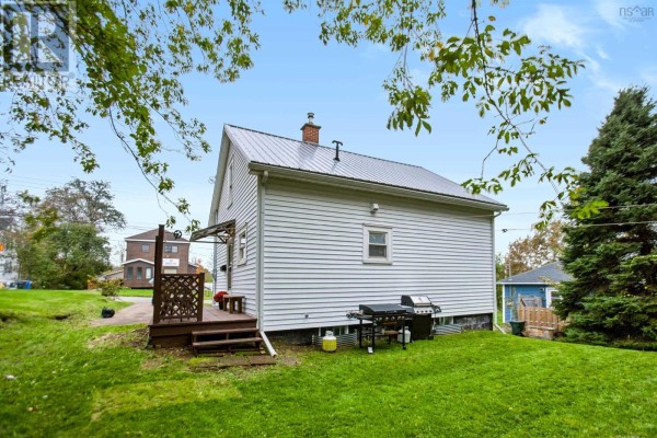 Rear exterior view of white clapboard house with wooden deck and grill. - 40 Charles Street, Amherst