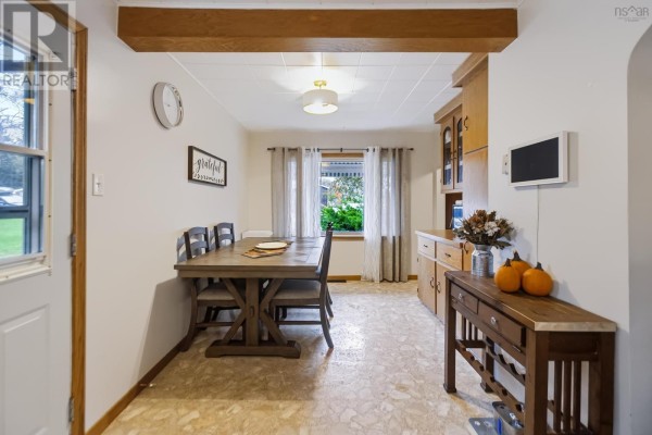 Dining area with wooden table, chairs, and built-in wooden cabinets. - 40 Charles Street, Amherst