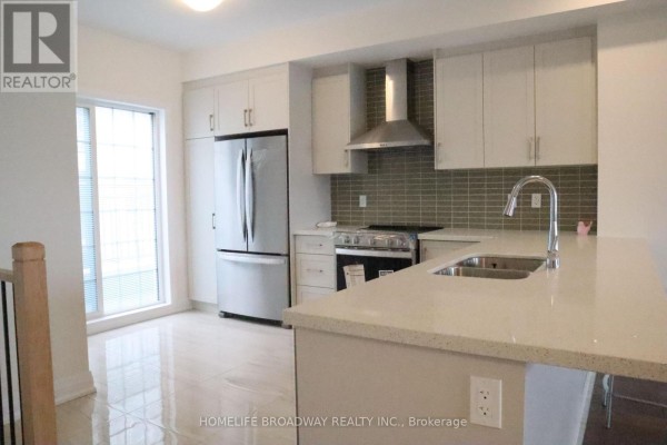 Laundry area featuring stacked white washer and dryer units - 40 Clippers Crescent, Whitchurch Stouffville