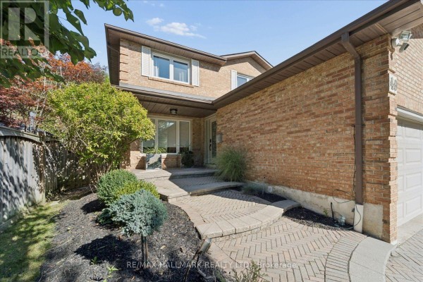 Pathway leading to the front entrance of a brick house with landscaping. - 40 Colonel Butler Drive, Markham